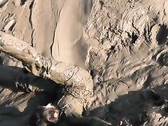 Filthy Mud Girl In Chest Waders Mucking Around